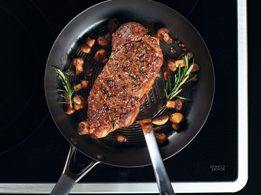 Braising steak in a frying pan with rosemary