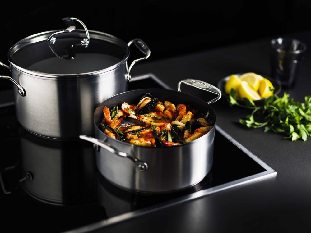 A stockpot on an induction hob with seafood