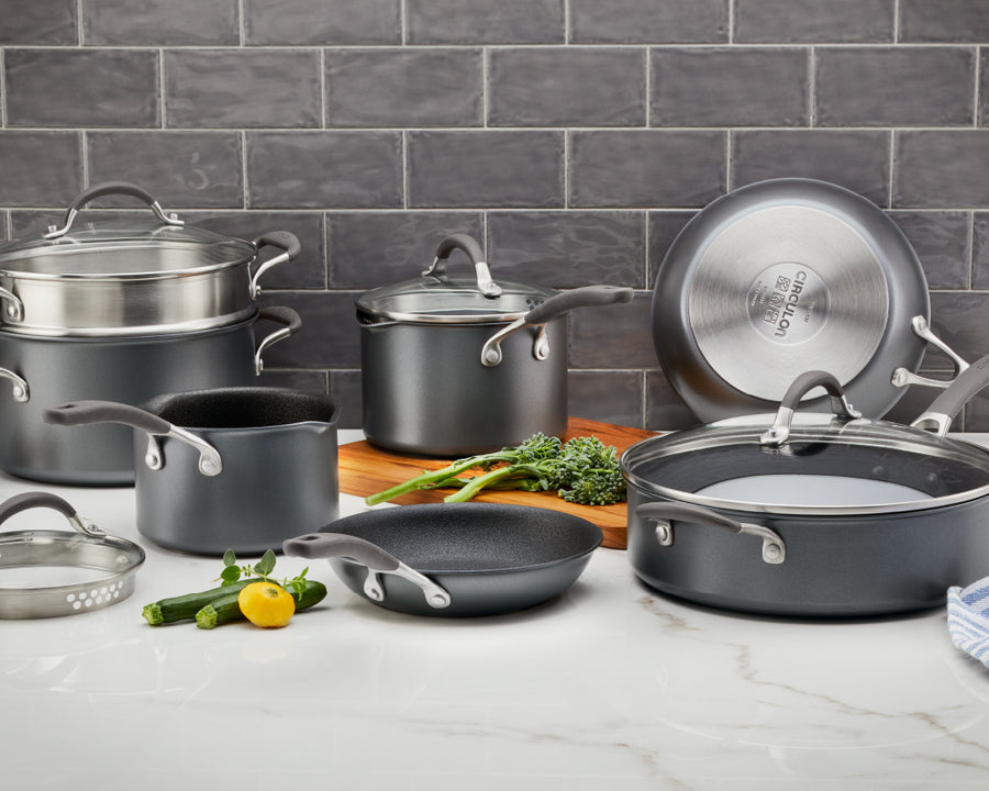 Circulon A1 ScratchDefense Extreme Non-Stick Cookware: frying pan, saute pan, stir fry wok, saucepans and lids displayed in a kitchen on a white worktop.