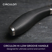 Close up of black kitchen knife handle. Text reads: Circulon hi-low groove handle designed for ultimate control and comfort.