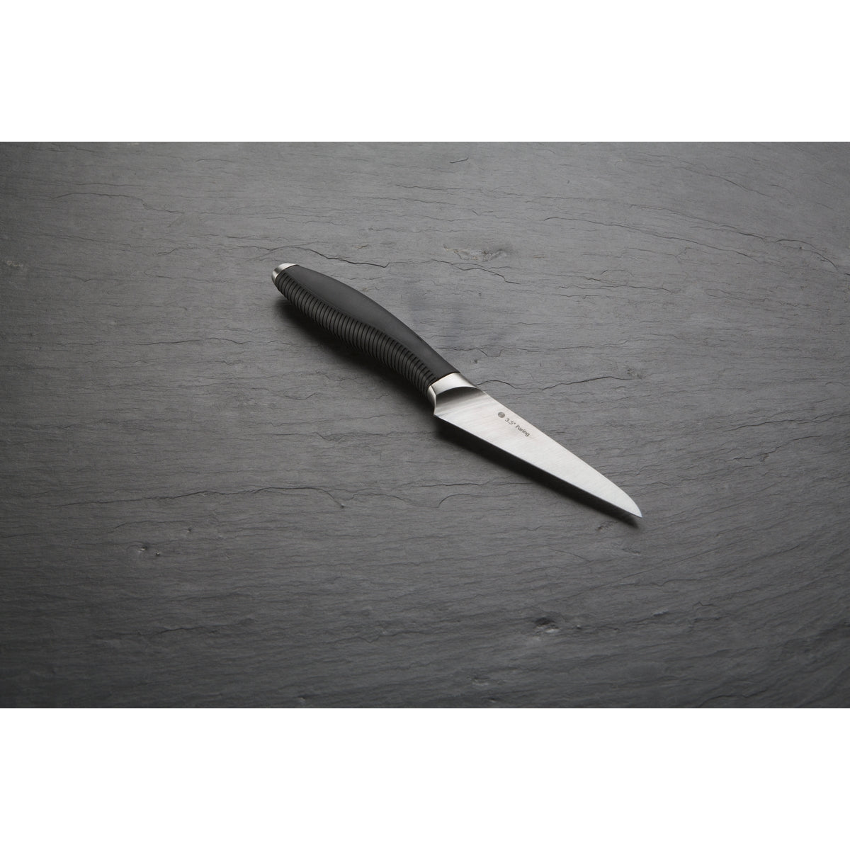 Image shows the paring kitchen knife on a grey background