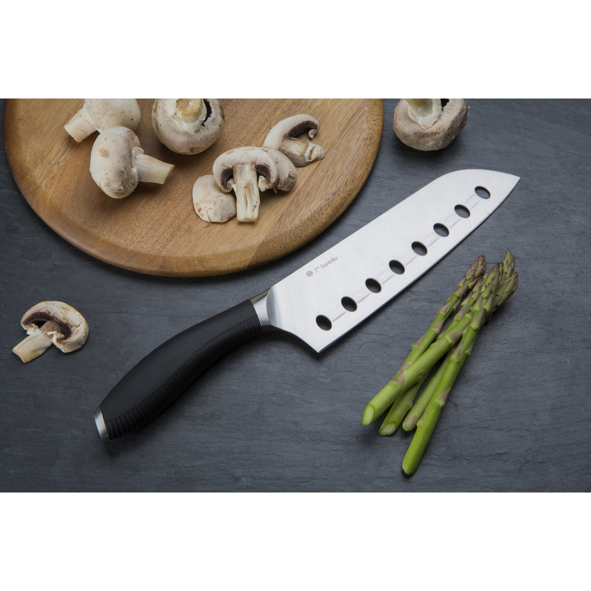 Santoku Knife with asparagus and sliced mushrooms.